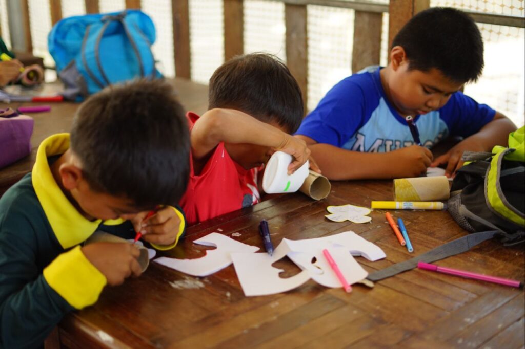 cambodian young boys during an arts and crafts workshop